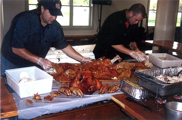 Caterers prepping fresh pork meat